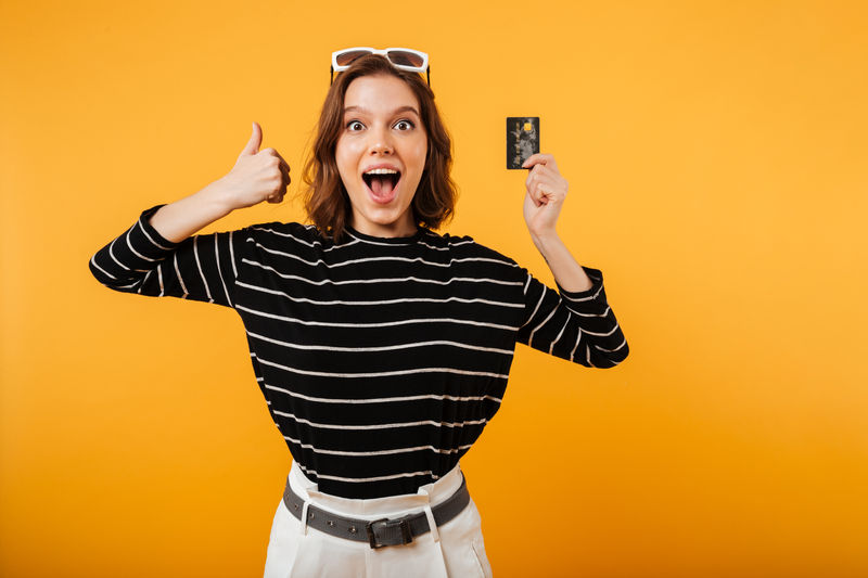 Happy customer holding a card — engagement and retention
